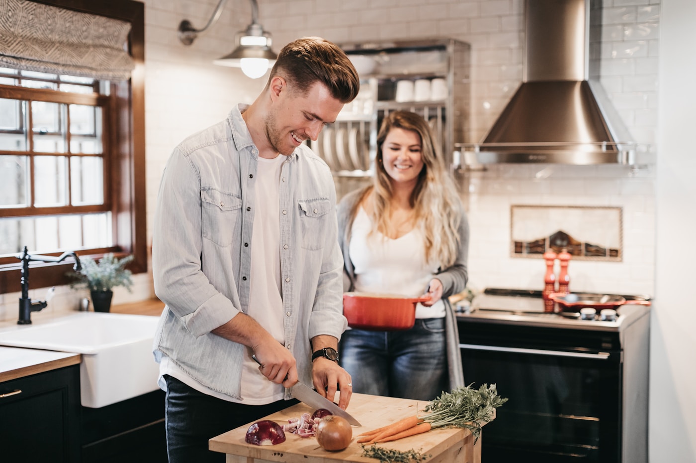 Two people enjoying cooking together at home